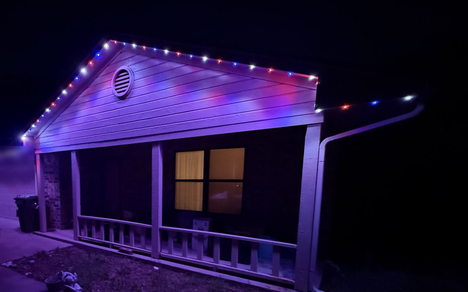 Real installed home with July 4th permanent lighting behind the fascia